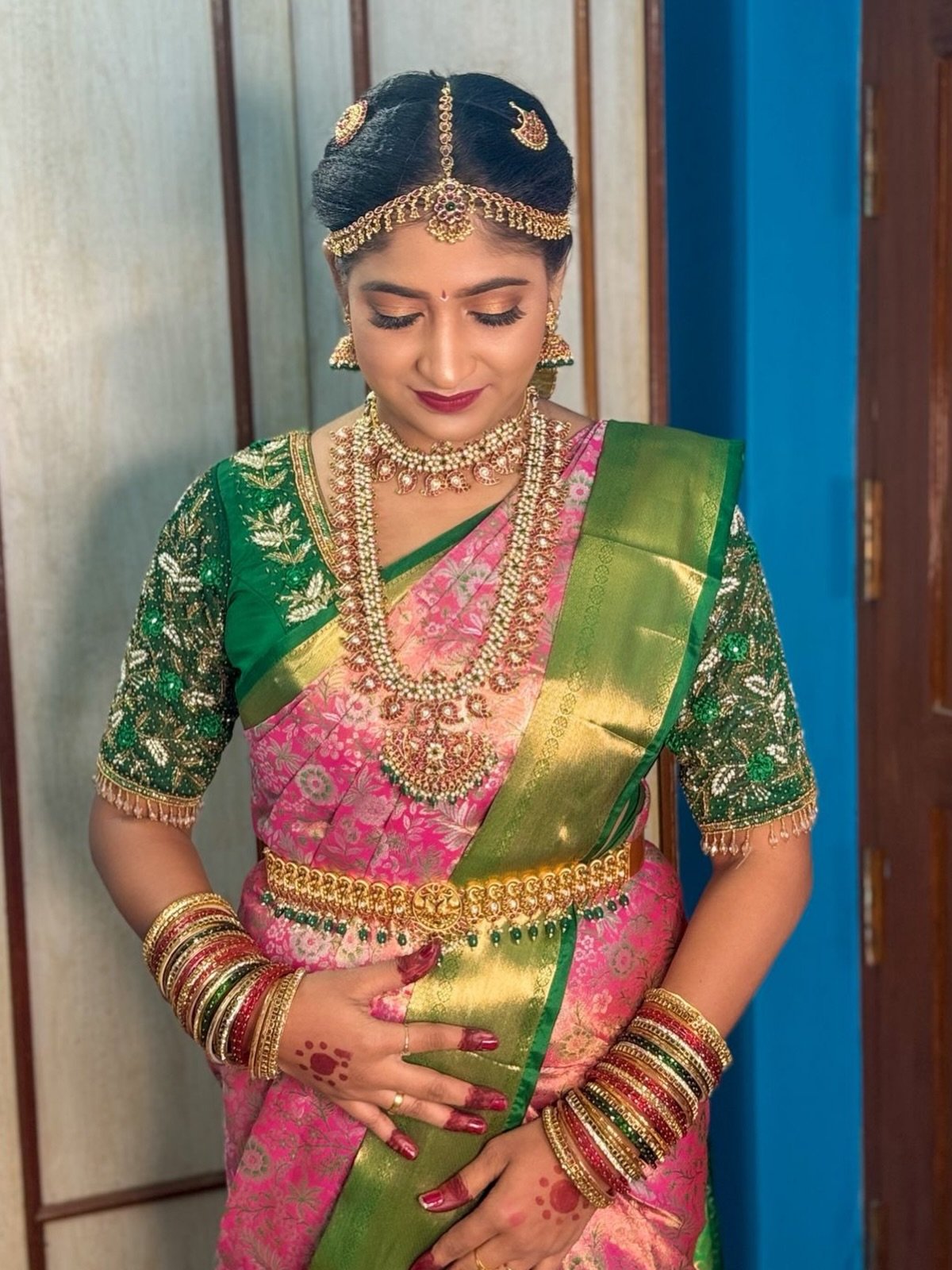 Bride in a blue silk saree with a classic red lip