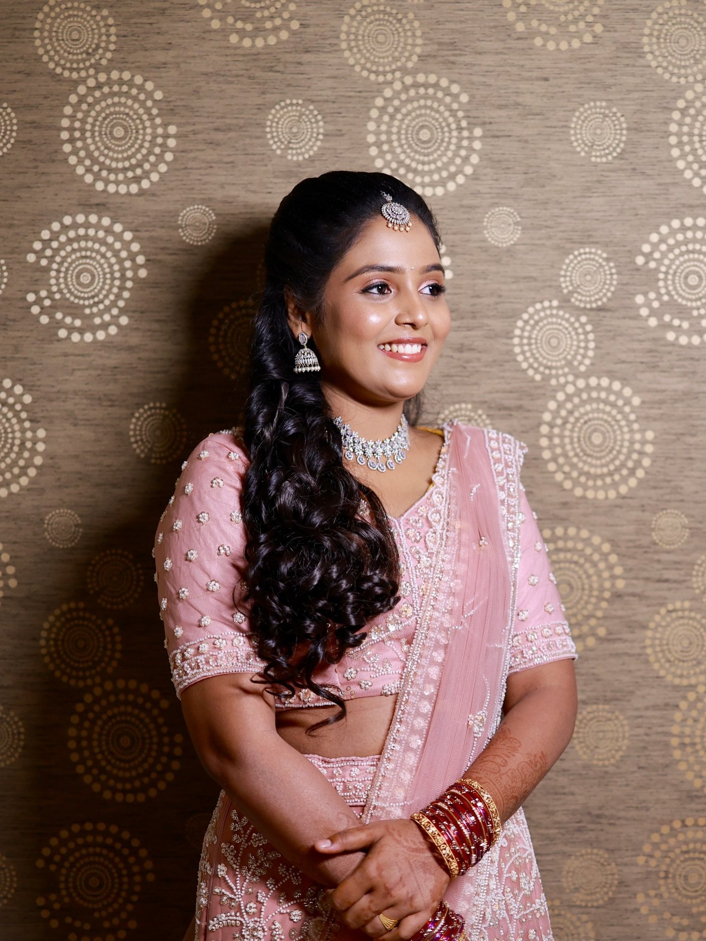 Bride in blush pink with luminous skin and soft eye makeup