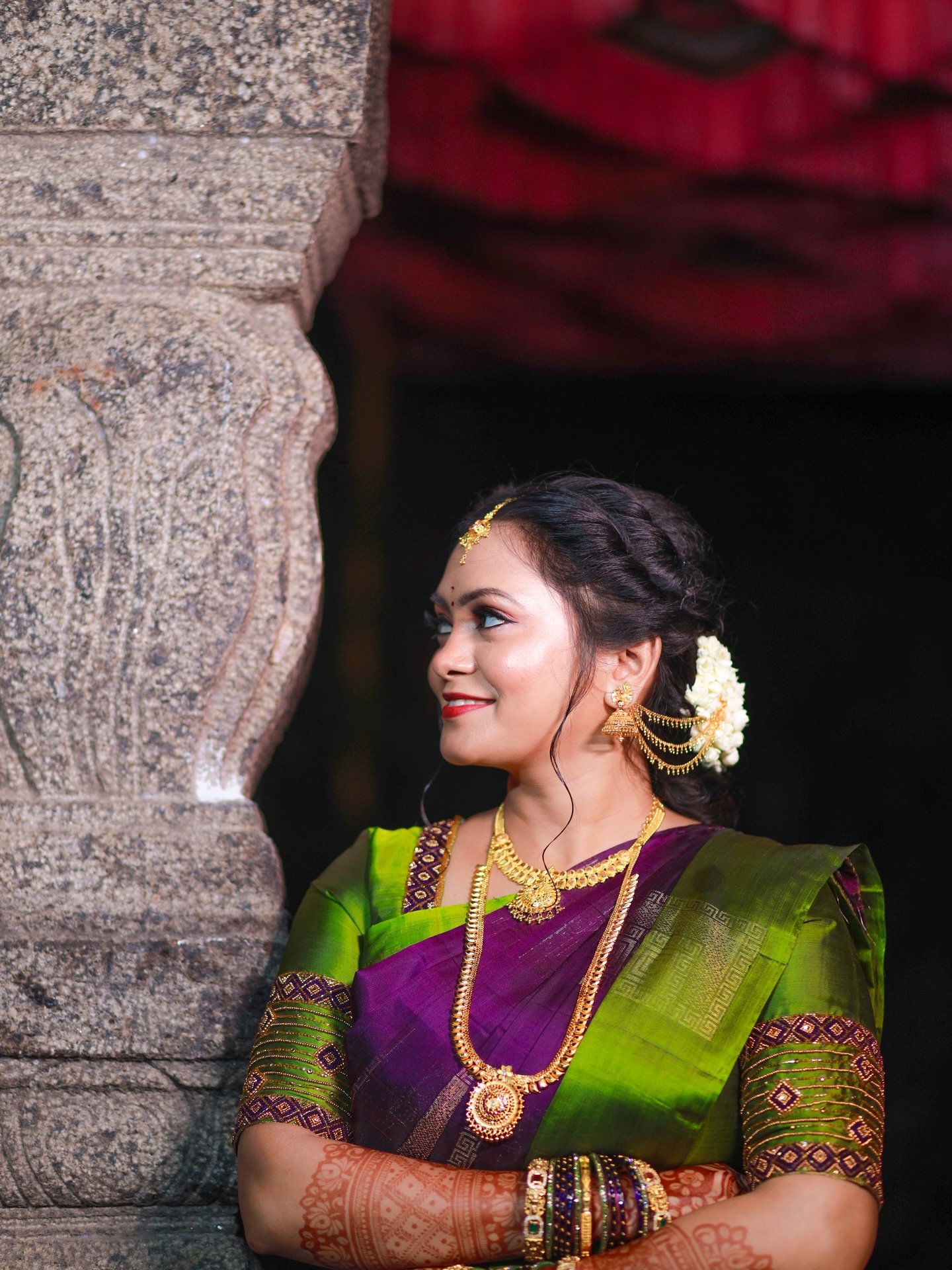 Bride in a green and purple silk saree with elegant makeup and hair