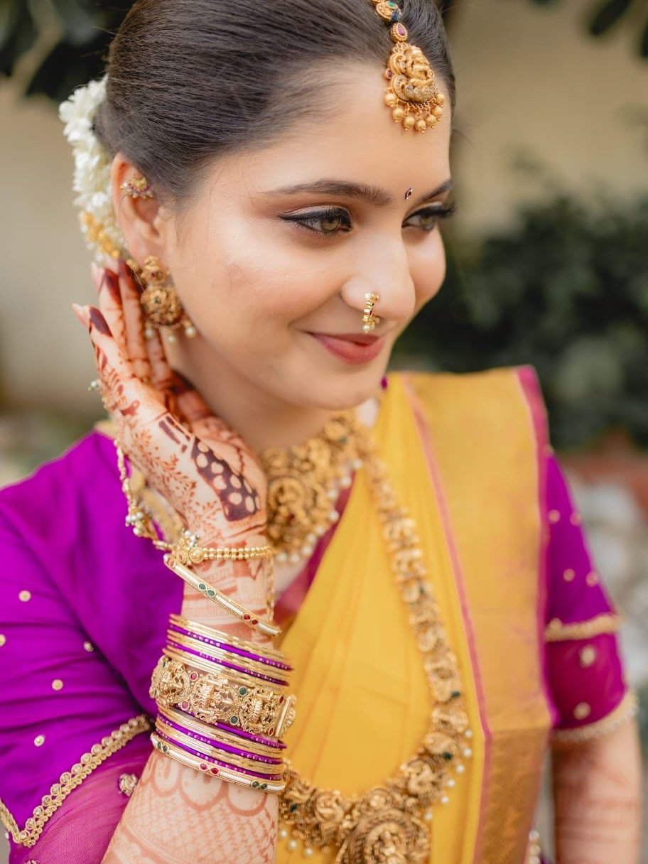 Bride in yellow and magenta with luminous traditional makeup